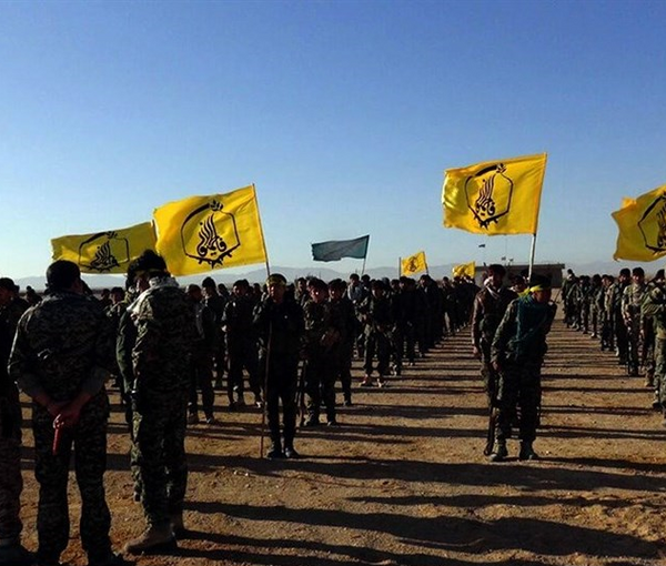 Fatemiyoun brigade fighters showcasing their flag in Syria (December 2016)