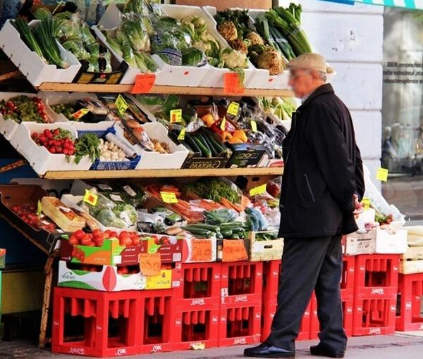 A man looking at rising prices in Tehran. Undated