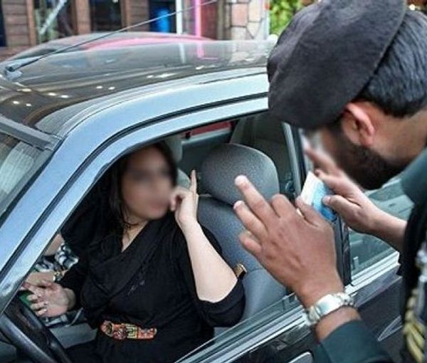 Woman arguing with a policeman in Tehran over her hijab. Undated