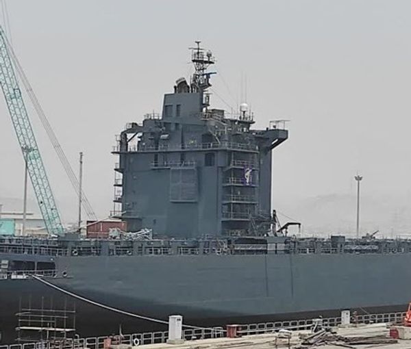 An Iranian ship being transformed into a navy vessel in a Persian Gulf port