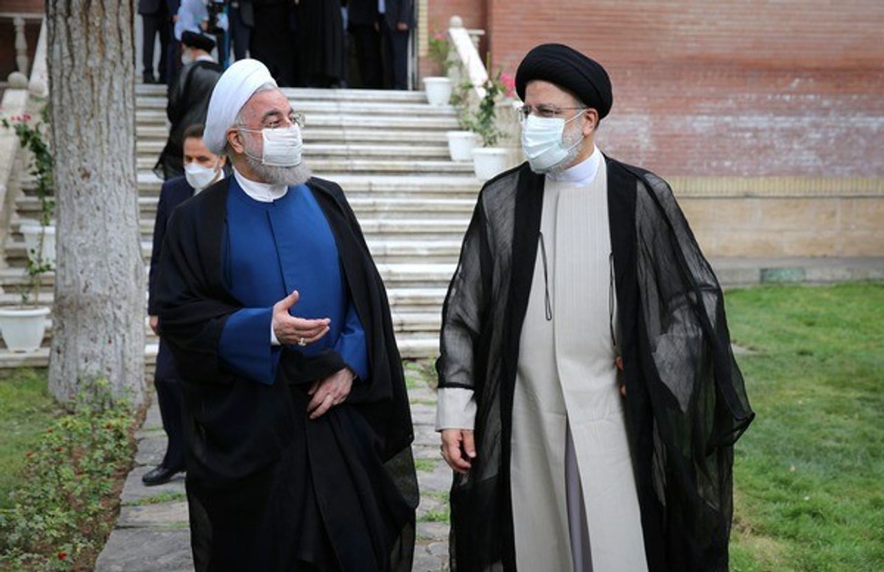 Hassan Rouhani (L) and newly elected Ebrahim Raisi in August 2021