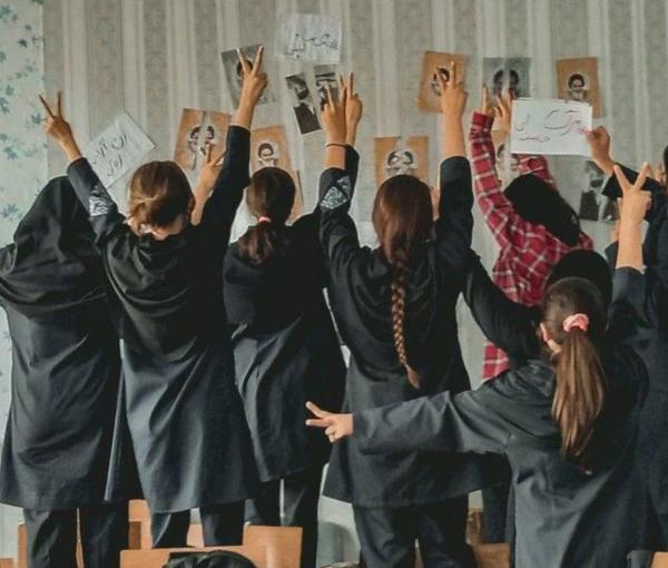 A group of schoolgirls unveiling in their classroom after tearing photos of the founder of the Islamic Republic Ruhollah Khomeini  (November 2022)