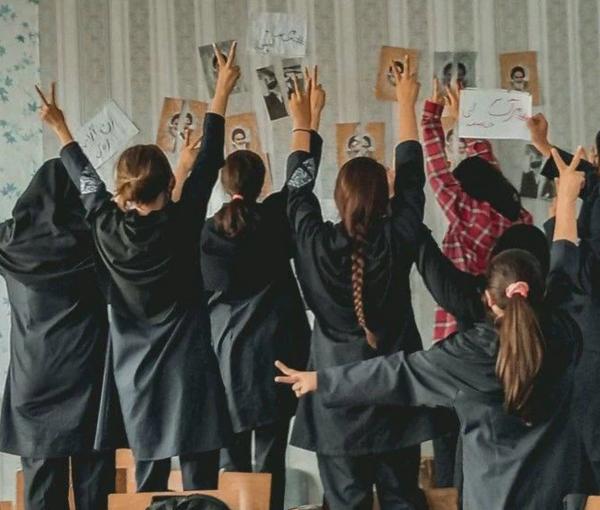 A group of schoolgirls unveiling in their classroom after tearing photos of the founder of the Islamic Republic Ruhollah Khomeini (November 2022)