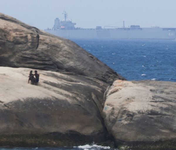 Iranian military ship Iris Makran navigates on the coast of Rio de Janeiro as beachgoers sunbathe on the stones of Arpoador Beach, Brazil, February 27, 2023.