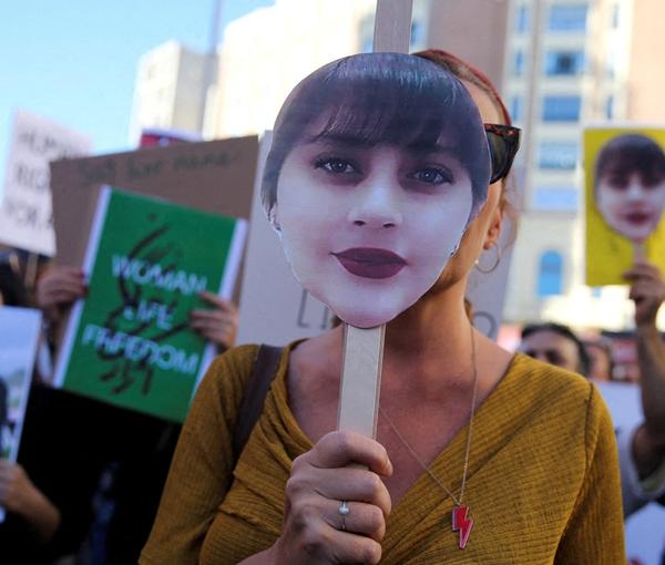 Protesters holding images of Mahsa Amini in a protest in Madrid, Spain on October 1, 2022