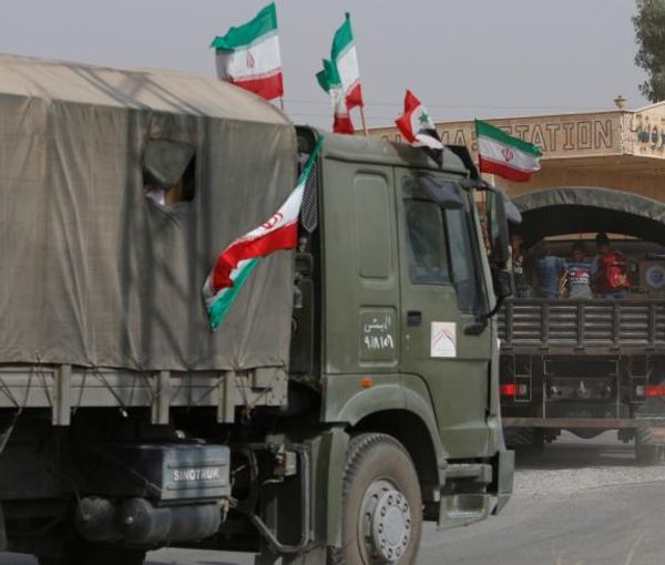 Iranian and Syrian flags flutter on a truck in Deir ez-Zor, Syria.  (September 2017)