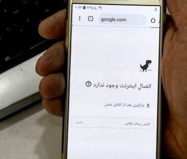 An Iranian man holding his phone while internet is down (file photo)