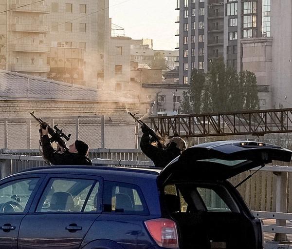 Ukrainian policemen use their assault rifles to fire at drones over Kyiv. October 17, 2022