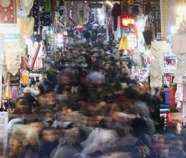 A long exposure image shows Iranians walking through Tehran Bazaar on February 1, 2023.