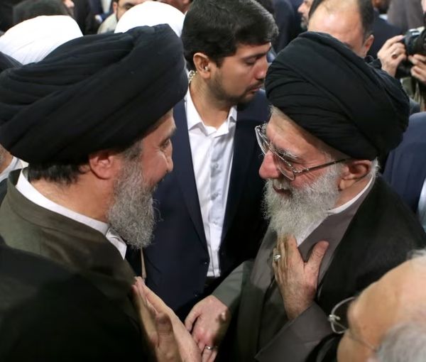 Hameed al-Hussaini, the director Iraq’s section of the Islamic Radio and Television Union, and Iran’s Supreme Leader Ali Khamenei (right) (undated)