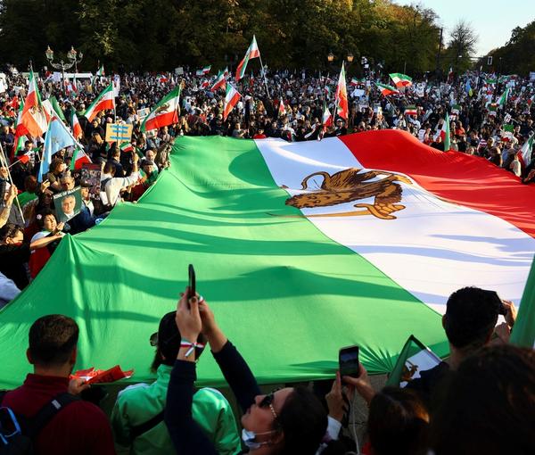 Tens of thousands of Iranian rallying in Berlin unfurled a large Iranian pre-revolution national flag with a lion in the middle, as opposed to the Islamic Republic emblem.