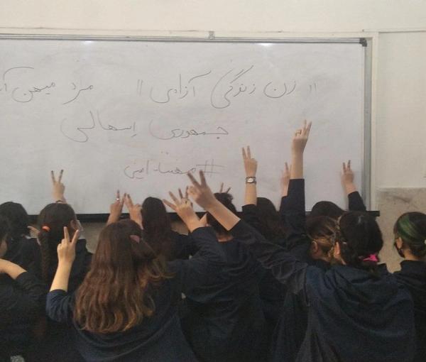 Several schoolgirls unveiling in their classroom in support of the Women, Life, Liberty movement (file photo)