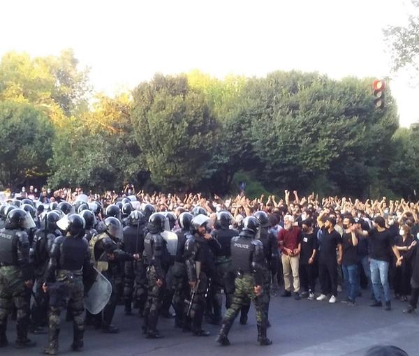 A large crowd of protesters in Tehran confronted by anti-riot forces, September 19, 2022