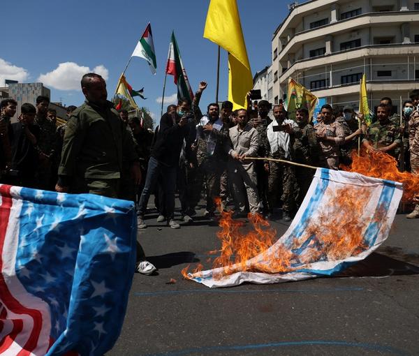 Iranians burn Israeli and U.S. flags during a rally marking the annual Quds Day, in Tehran, April 14, 2023