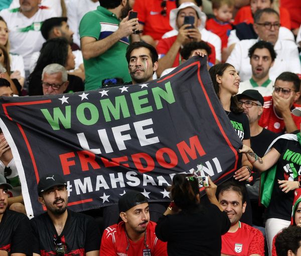 Iran fans hold a banner reading 'Woman life freedom' inside the stadium during the match against England on November 21, 2022.  