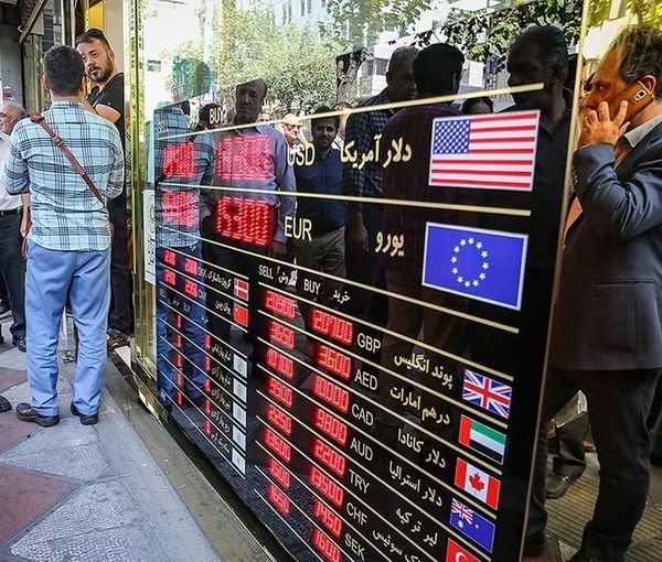 People looking at a board that shows exchange rates against rial (file photo)