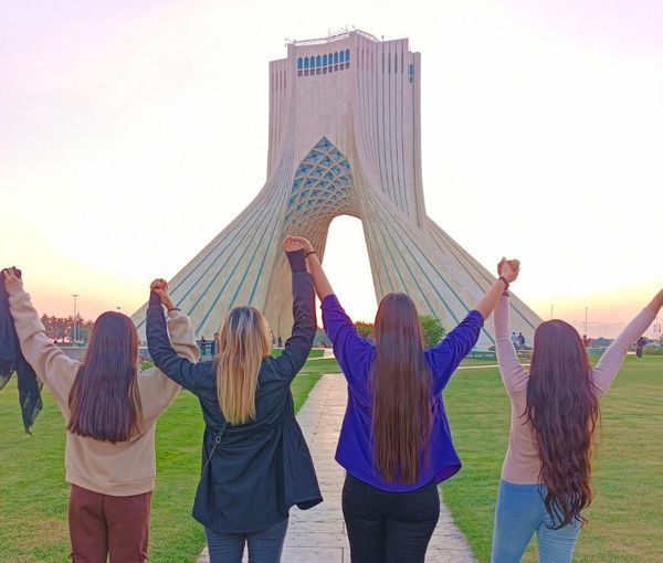 Several Iranian women remove their headscarves in front of Tehran’s iconic Azadi tower, formerly known as the Shahyad Tower. (undated)
