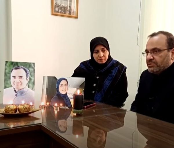Assadi-Lari family during their interview with photos of their children
