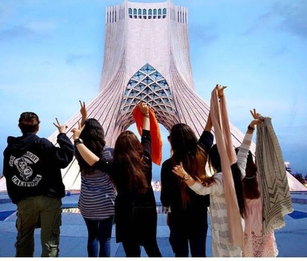 Young Iranian women removing their headscarves