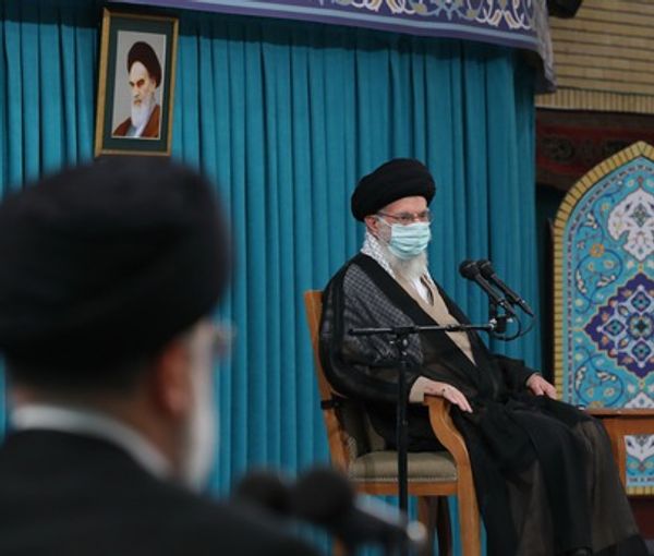 Iran's ruler Ali Khamenei speaking on August 30, 2022 while president Raisi is listening