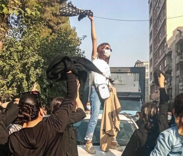 Iranian protesters chanting slogans while unveiling in public  (December 2022)