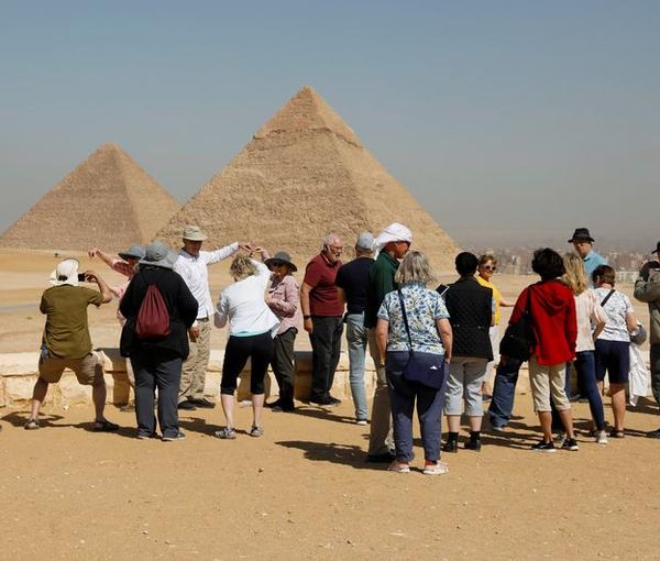 Tourists gather at the Great Pyramids of Giza, on the outskirts of Cairo, Egypt March 8, 2020.