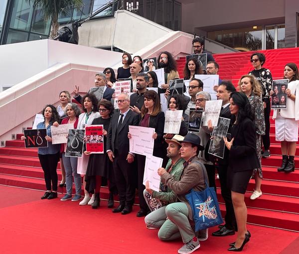 A group of artists at the Cannes Film Festival holding placards in protest to the Islamic Republic’s executions (May 2023) 