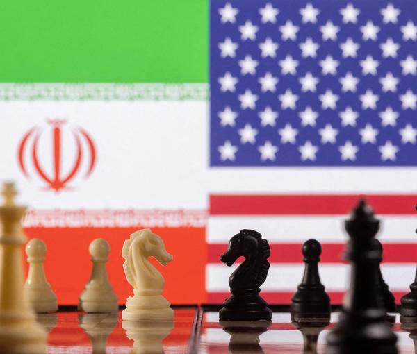 Chess pieces are seen in front of displayed Iran's and US flags in this illustration taken January 26, 2022.