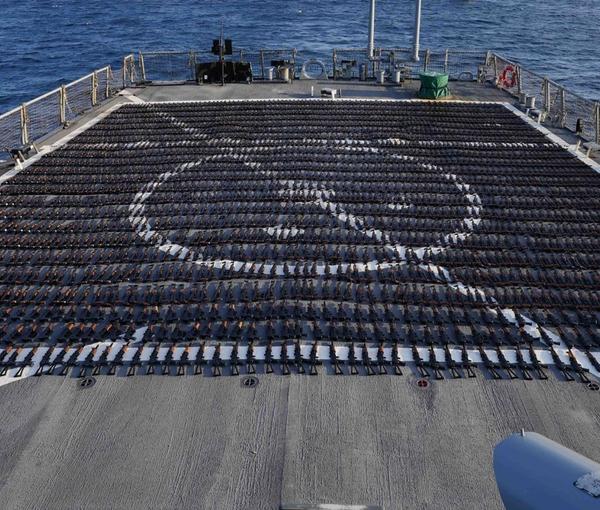 Thousands of AK-47 assault rifles sit on the flight deck of guided-missile destroyer USS The Sullivans (DDG 68) during an inventory process on January 7, 2023.