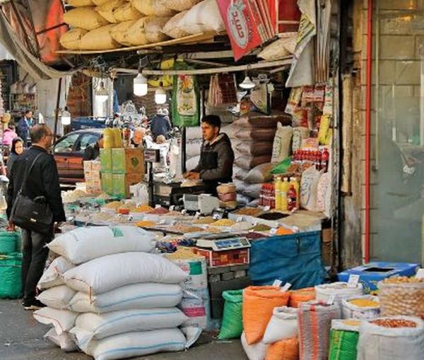 Shopper outside a food store in Iran. Undated