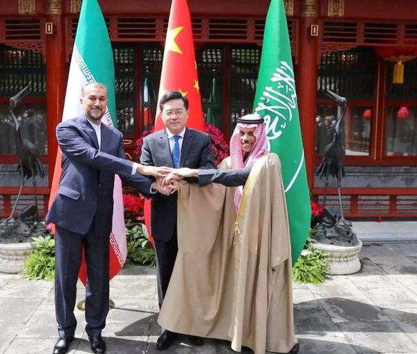 Hossein Amir-Abdollahian and Saudi Arabia's Foreign Minister Prince Faisal bin Farhan Al Saud and Chinese Foreign Minister Qin Gang shake hands during a meeting in Beijing, April 6, 2023