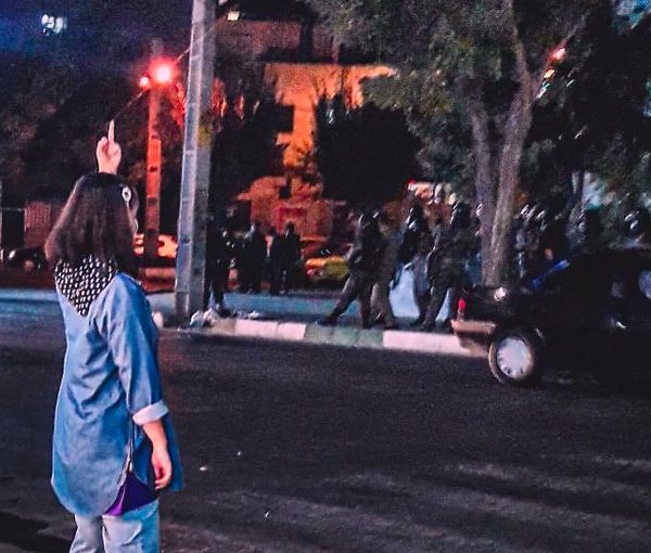 A female protester defying anti-riot troops in Iran. Undated