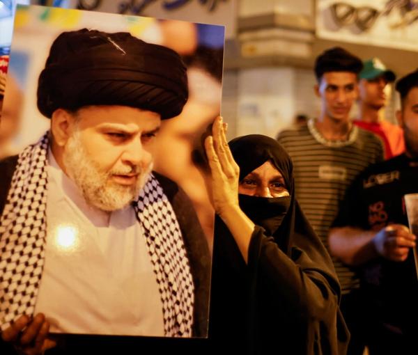 Muqtada al-Sadr's supporters holding up his picture. Undated