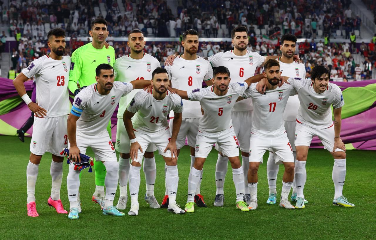 Iran players pose for a team group photo before the match 