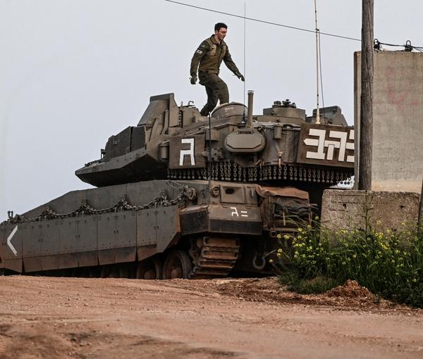 An Israeli soldier walks on top of a tank near Shtula, by the Israel Lebanon border, in northern Israel April 6, 2023.