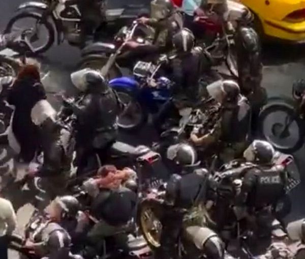 Special police units on motorcycles assaulting a woman in Tehran on Oct. 23, 2022