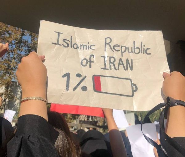 A student holding a sign in a Tehran university showing the Islamic Republic becoming weaker. Nov. 1, 2022