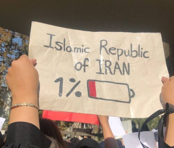 A student holding up a placard during a protests in Tehran University in November 2022