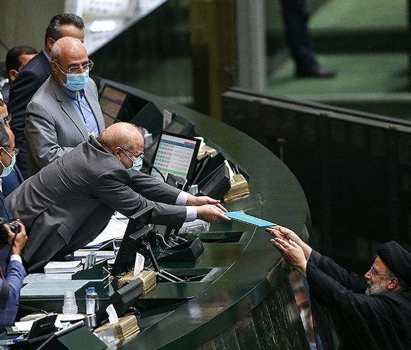 Iran's President Ebrahim Raisi Handing the new budget to Parliament Speaker Ghalibaf on December 12, 2021