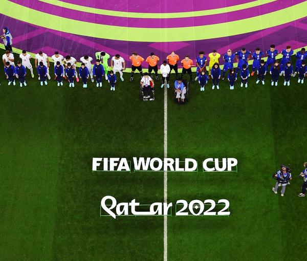 Iranian and US teams and match officials line up before their World Cup match at Doha’s Al Thumama Stadium, Qatar, on November 29, 2022