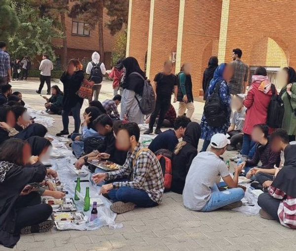 Students eating lunch outside the cafeteria in Sharif University on October 24m 2022