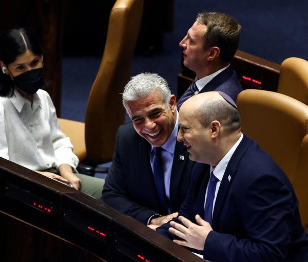 Lapid and Bennett joking in a Knesset meeting on June 30, 2022