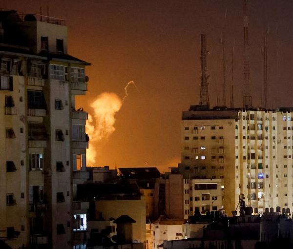 Flames rise above Gaza City, during an Israeli air strike on April 7, 2023. 