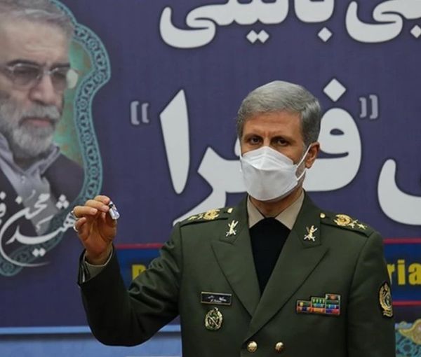 Iran's Fakhra vaccine displayed against a backdrop showing Mohsen Fakhrizadeh, the nuclear scientist assassinated last year.