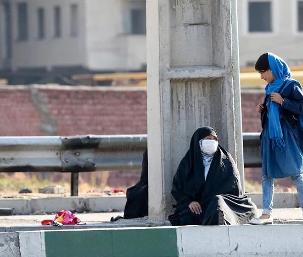 An Iranian woman begging for money on a street in Tehran (file photo)