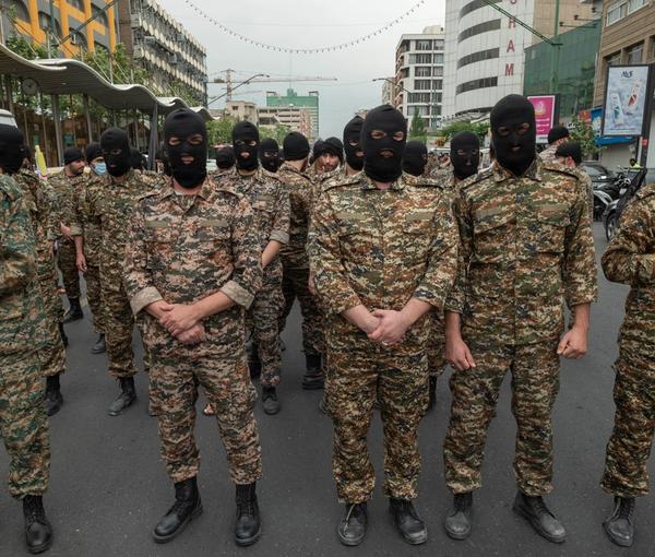Revolutionary Guard (IRGC) military personnel stand guard on an avenue in downtown Tehran during Quds Day on April 29, 2022. 