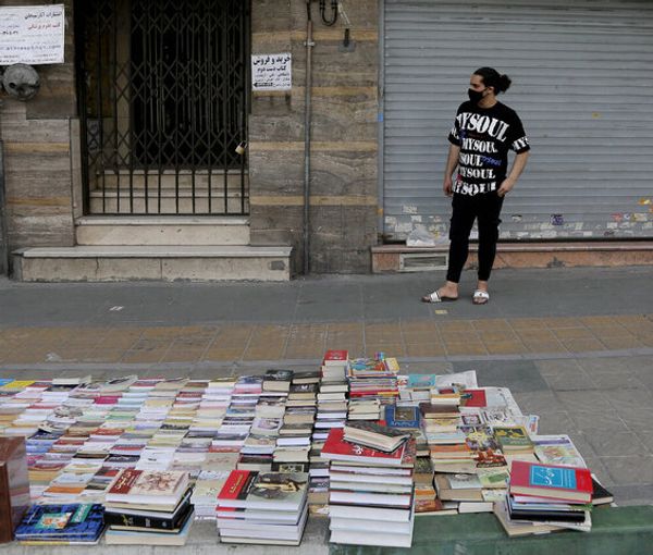 Book sellers in a Tehran street. Undated