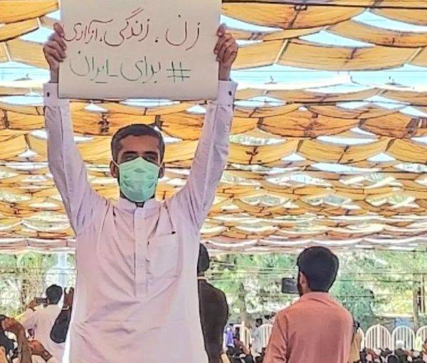 A protester in Zahedan holding a banner of the main slogan of the current wave of protests: Women, Life, Liberty (October 28, 2022)