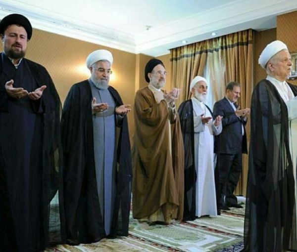 Former president Akbar Hashemi Rafsanjani leading a prayer with Ayatollah Ruhollah Khomeini's grandson Hassan Khomeini (left), former presidents Hassan Rouhani (2nd left) and Mohammad Khatami (center), former parliament speaker Ali Akbar Nateq-Nouri (2nd right) and former vice president Eshaq Jahangiri (right) standing behind him (undated)