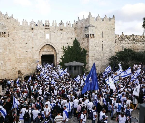 Israelis sing and dance with flags by Damascus gate to Jerusalem's Old city as they mark Jerusalem Day, in Jerusalem May 18, 2023.